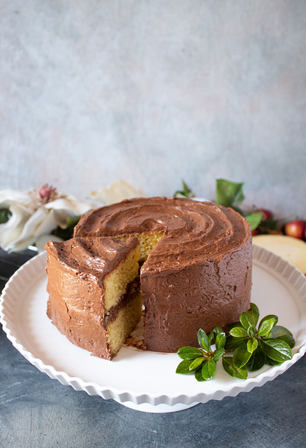 Keto Birthday Cake Recipe - Whole cake sliced showing both layers plus frosting in between.