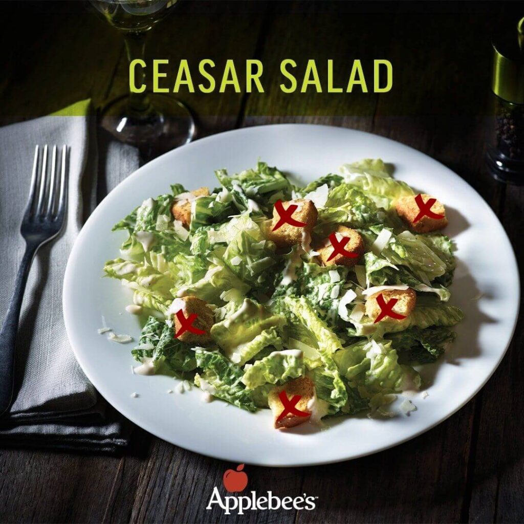 Image of a keto-friendly Caesar salad from Applebee's restaurant, sans croutons, a low-carb option with approximately 170 calories and only 2 grams of net carbs.